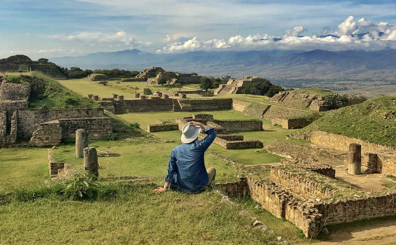 Traveler overlooking the Monte Albán archaeological site and Oaxaca’s Central Valleys